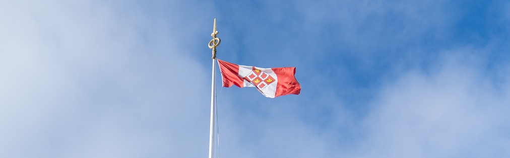 The Supreme Court of Canada flag flying against a blue sky