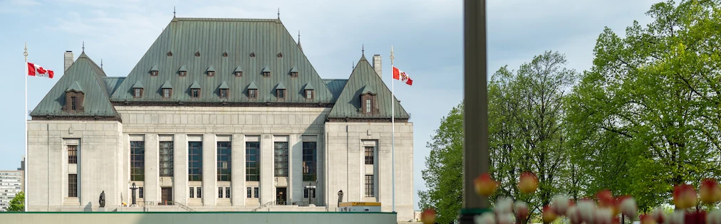 The exterior of the Supreme Court of Canada building in the spring