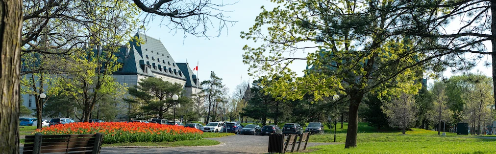 The exterior of the Supreme Court of Canada building in the spring