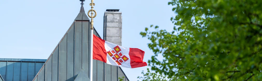 The Supreme Court of Canada flag flying in front of the building