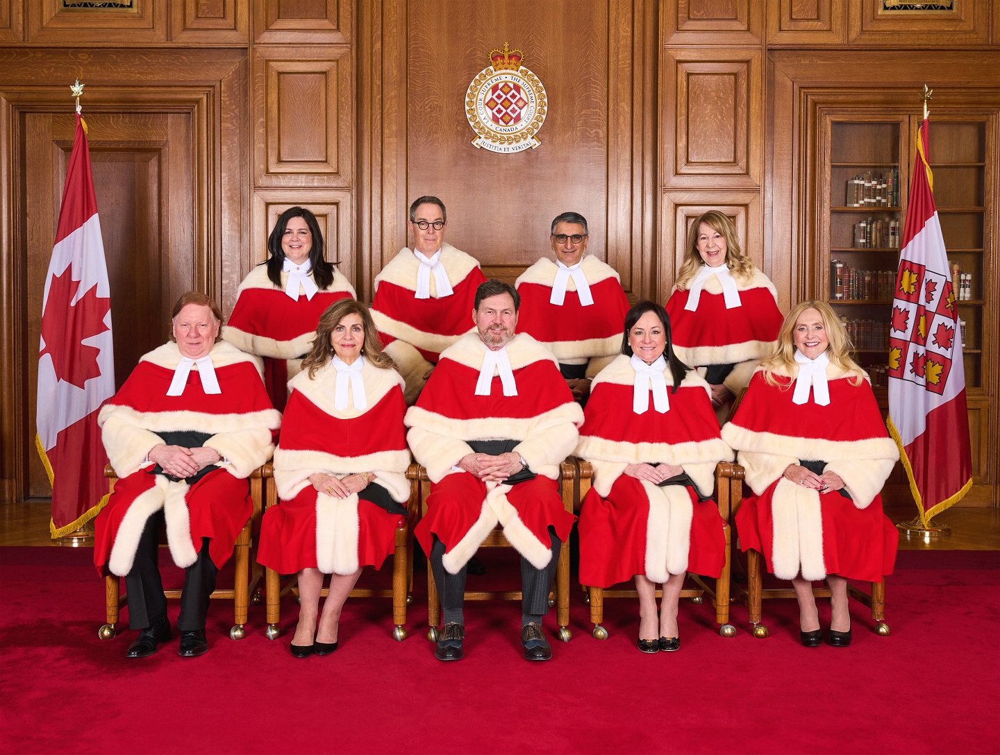 Official bench photo of the 9 Supreme Court of Canada judges in their red ceremonial robes.