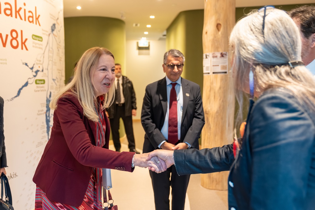 Justice Moreau shakes hands with Vicky Boldo while Justice Jamal looks on.