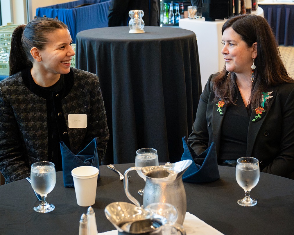 Justice O’Bonsawin speaking to a new lawyer at a reception.